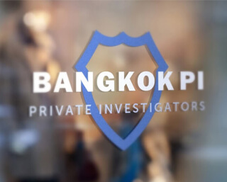 Bangkok Private Investigators logo on a glass door
