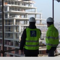  Construction professionals looking out on building project.